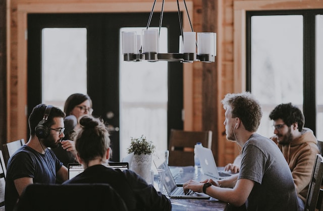 People sitting at table using laptops