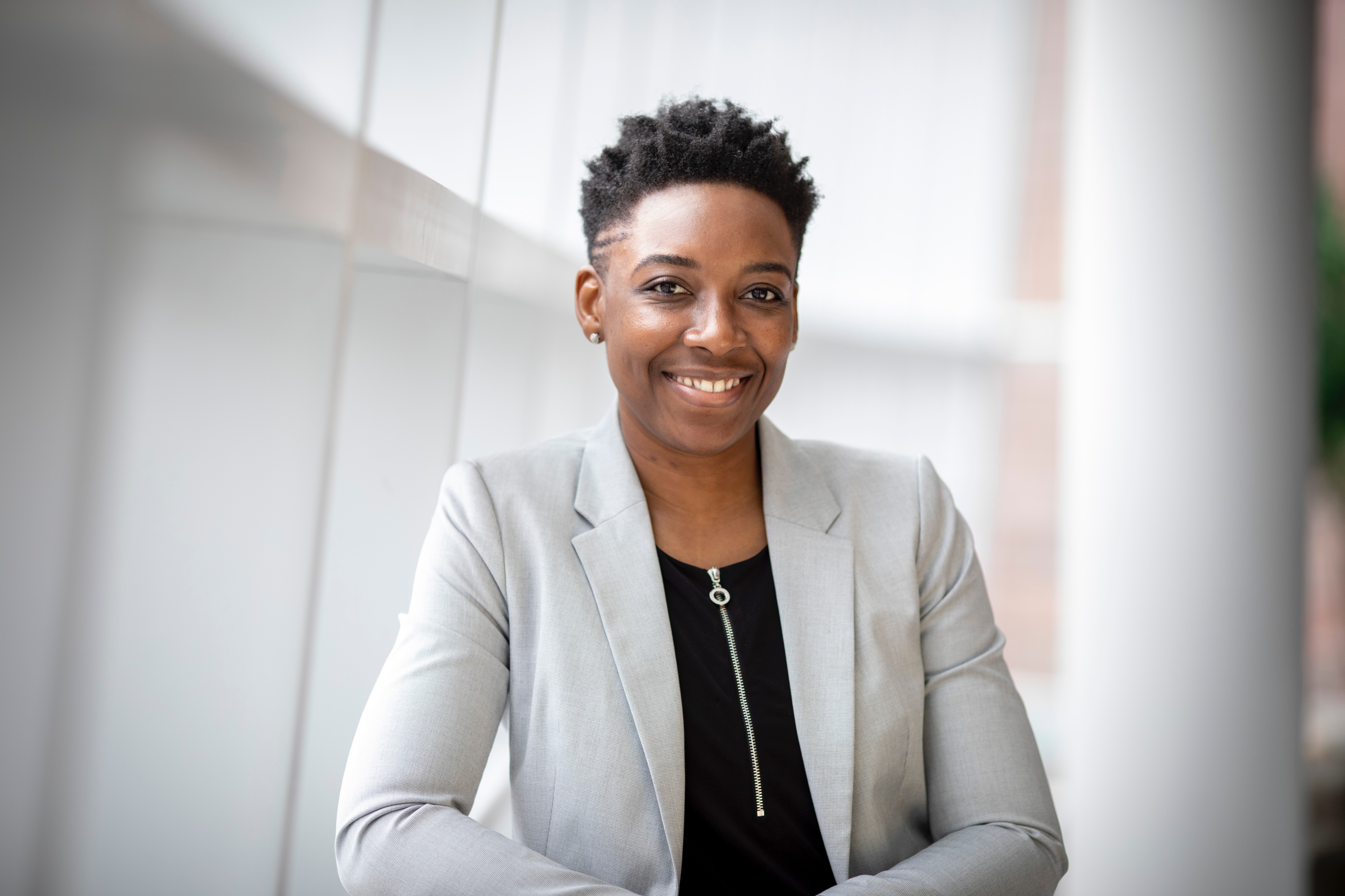 Smiling woman wearing grey blazer 