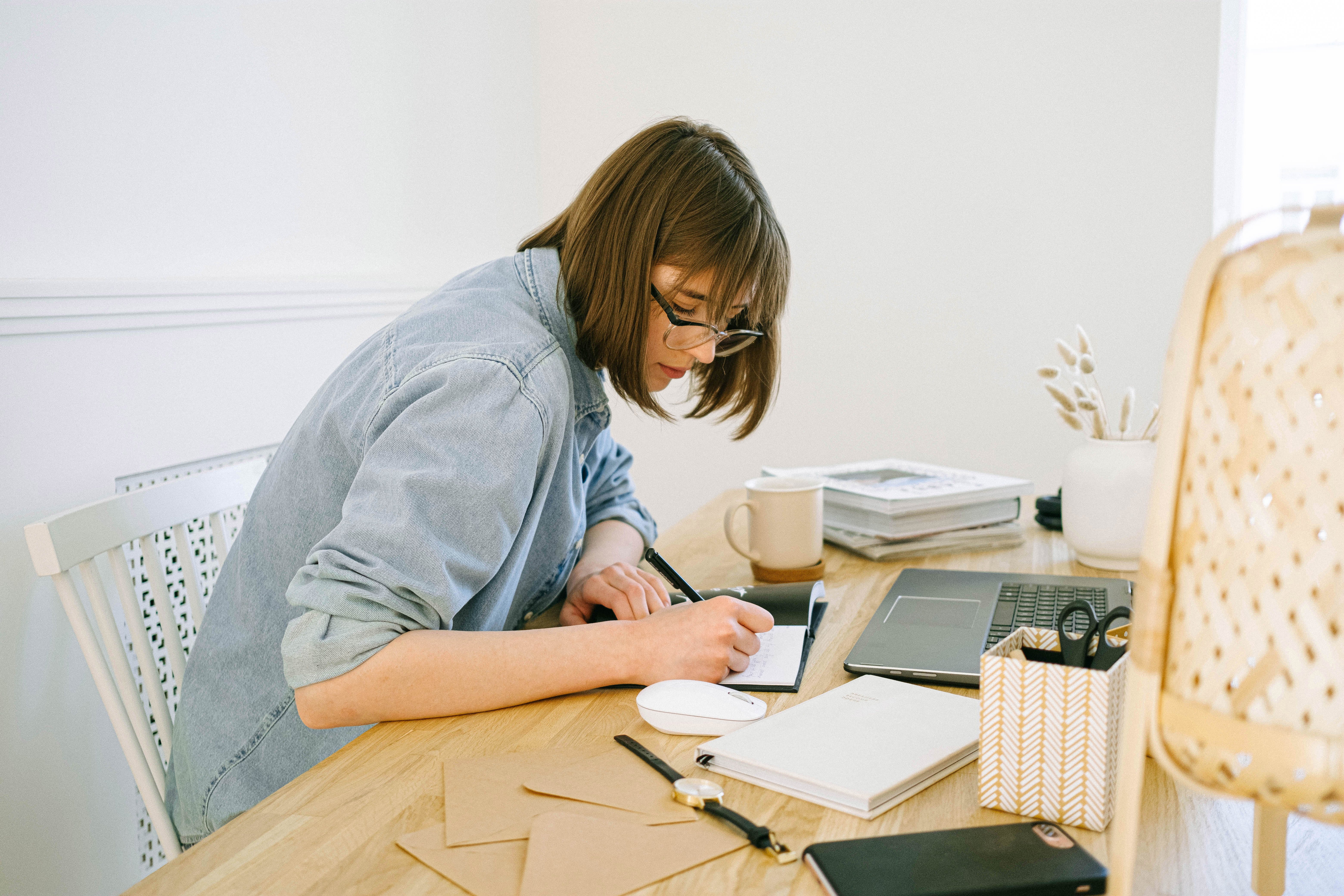 woman writing on desk