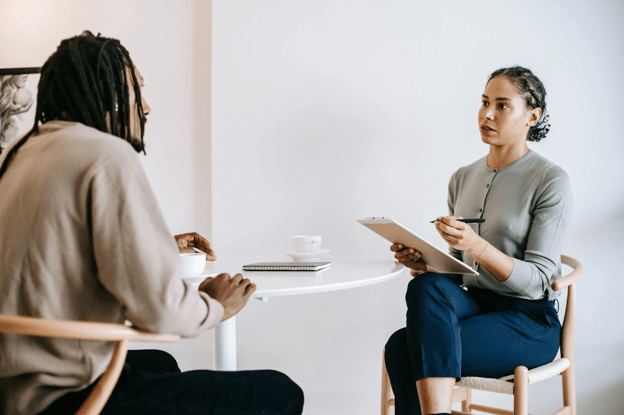 Two person interview with notepad