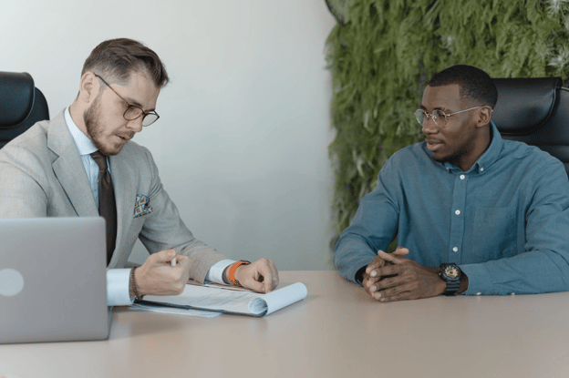 two well-dressed men taking notes